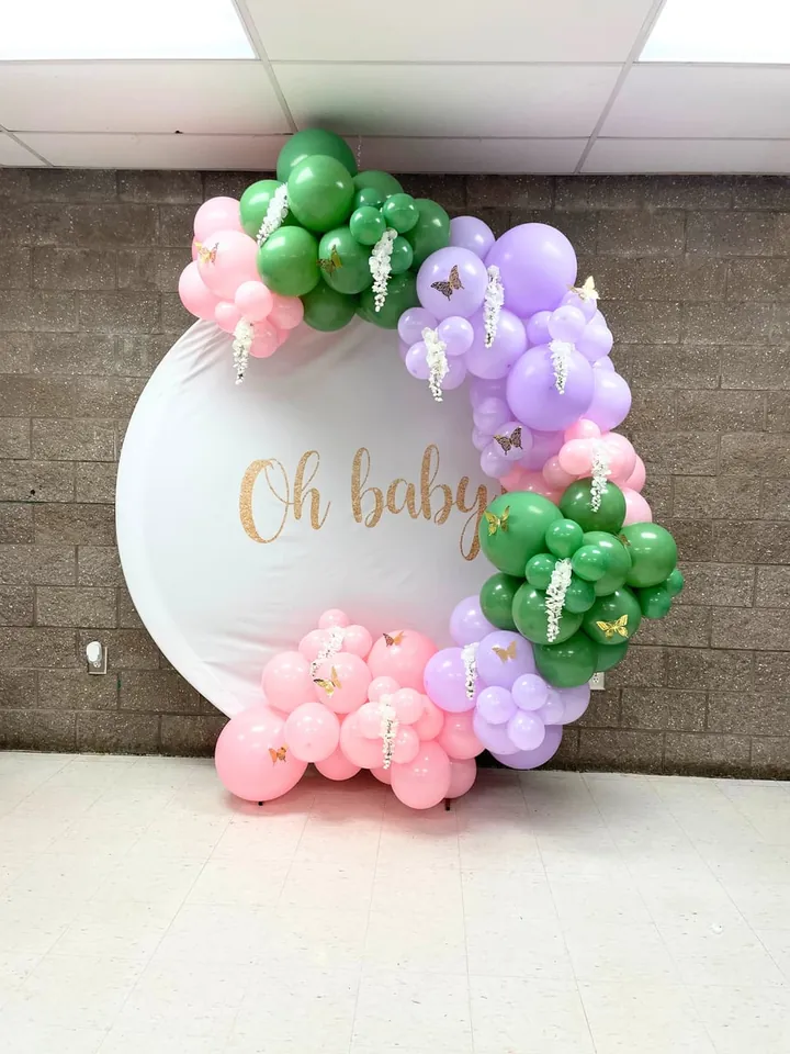 Pastel green, pink and lavender organic balloon garland on a round Oh Baby backdrop for a Tampa baby shower by CAJE Creations
